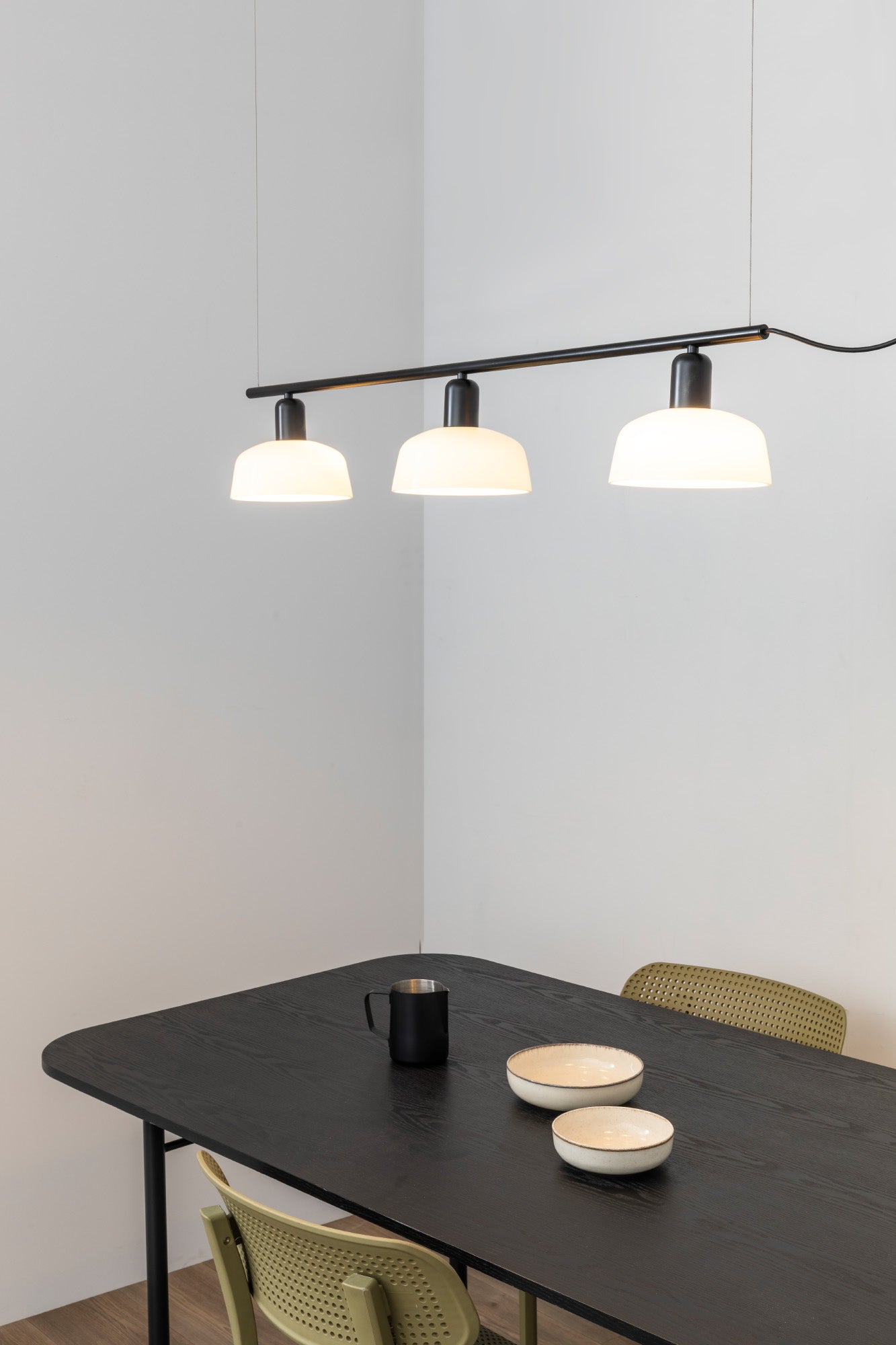 Faro Barcelona Tatawin medium 3 light linear pendant in white hanging over a dining table