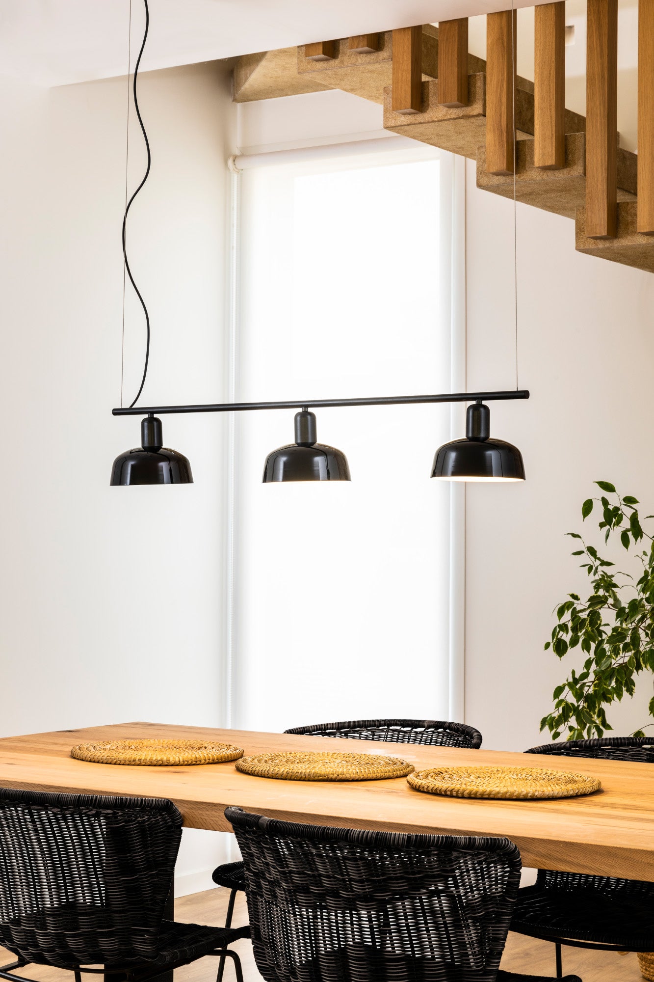 Faro Barcelona Tatawin medium 3 light linear pendant in Black over a dining table