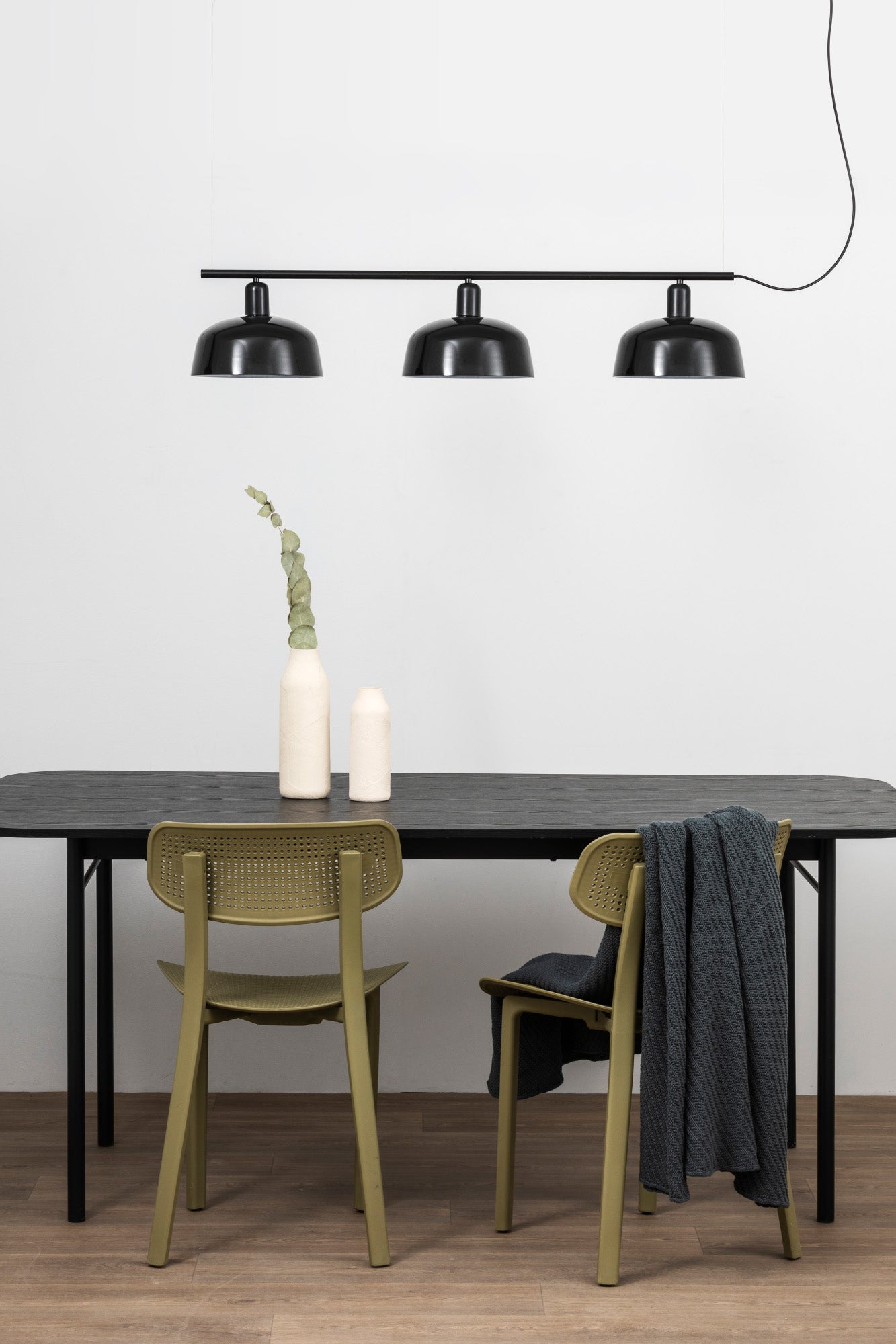 Faro Barcelona Tatawin medium 3 light linear pendant in Black hanging over a dining table