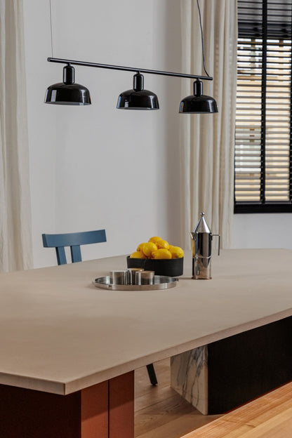 Faro Barcelona Tatawin medium 3 light linear pendant in Black hanging over a dining table