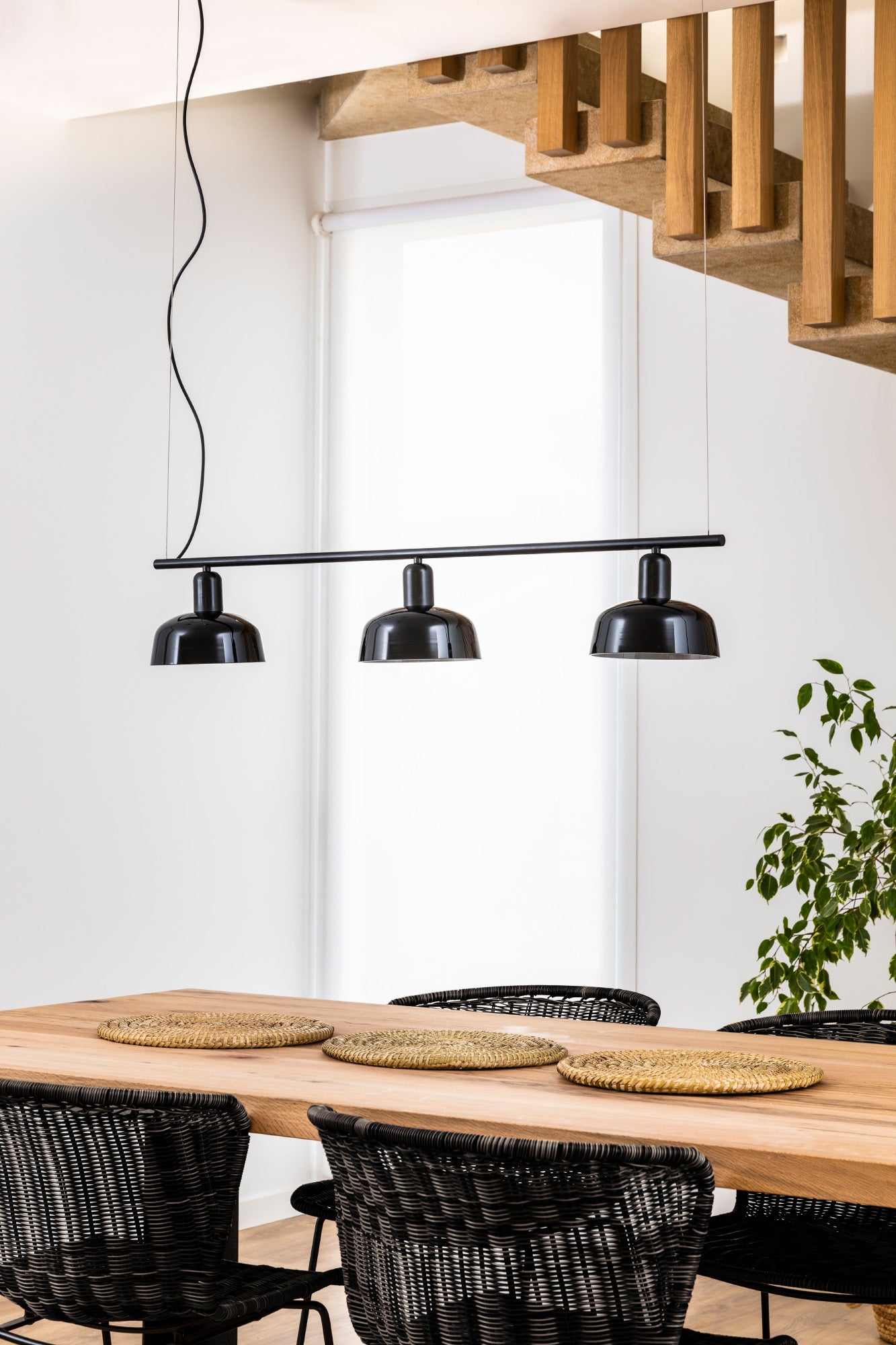 Faro Barcelona Tatawin medium 3 light linear pendant in Black hanging over a dining table