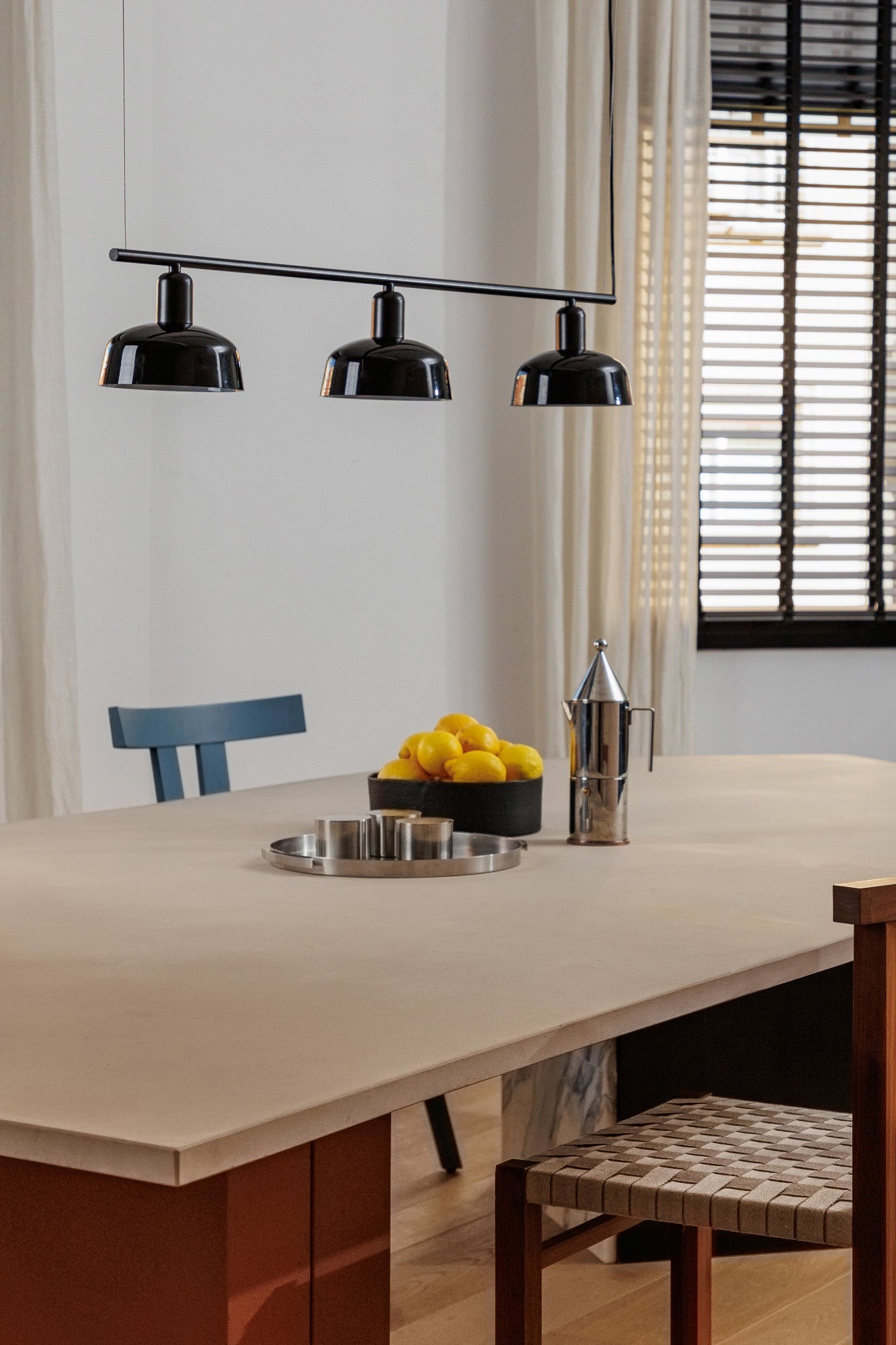 Faro Barcelona Tatawin medium 3 light linear pendant in Black hanging over a dining table