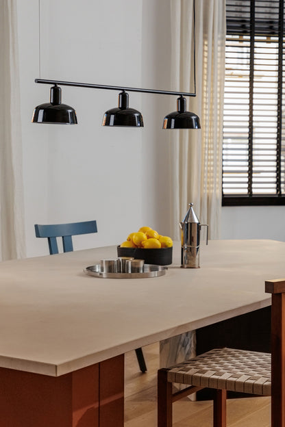 Faro Barcelona Tatawin medium 3 light linear pendant in Black hanging over a dining table