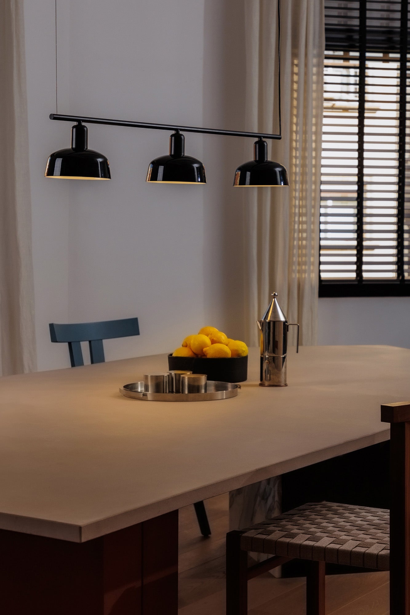 Faro Barcelona Tatawin medium 3 light linear pendant in Black hanging over a dining table