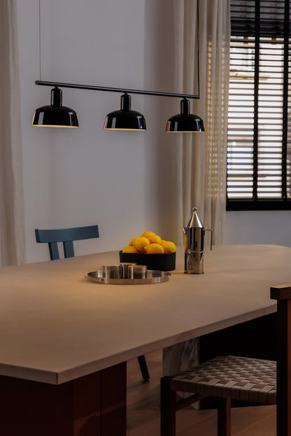 Faro Barcelona Tatawin medium 3 light linear pendant in Black hanging over a dining table