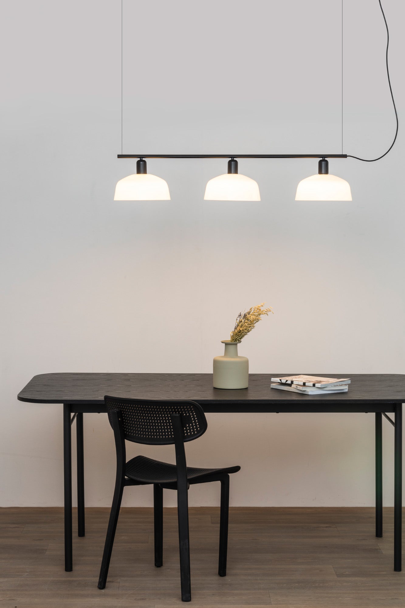 Faro Barcelona Tatawin medium 3 light linear pendant in white hanging over a dining table