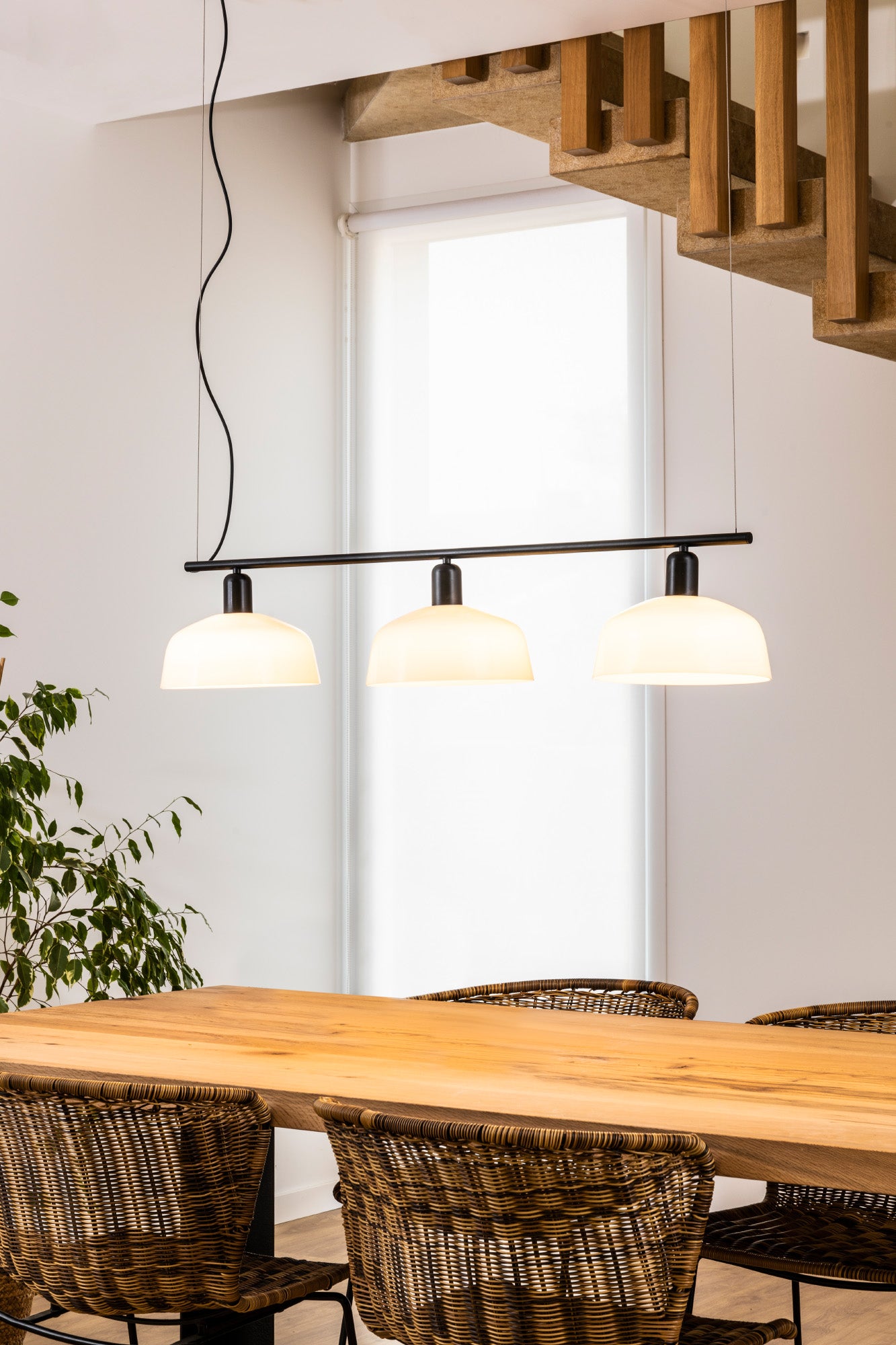 Faro Barcelona Tatawin 3 light linear pendant in White hanging over a dining table