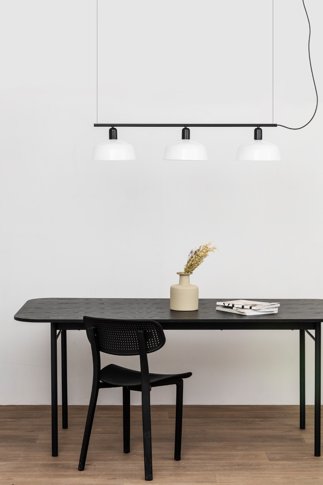 Faro Barcelona Tatawin medium 3 light linear pendant in white hanging over a dining table