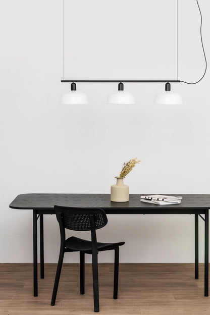 Faro Barcelona Tatawin medium 3 light linear pendant in white hanging over a dining table