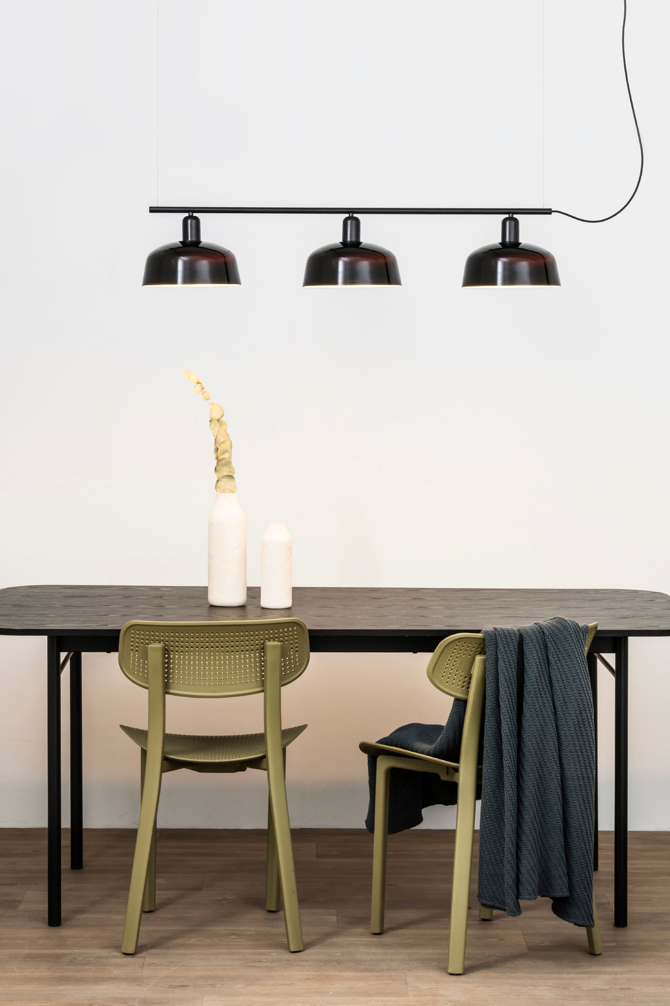 Faro Barcelona Tatawin medium 3 light linear pendant in Black hanging over a dining table