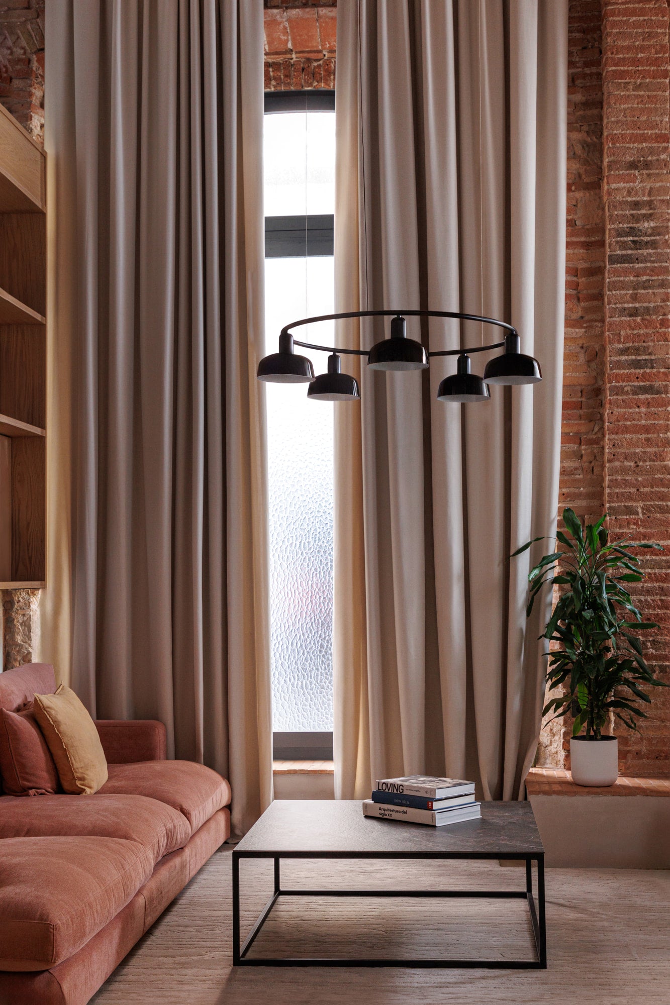 Faro Barcelona 5 Light Circular pendant in Black over a coffee table