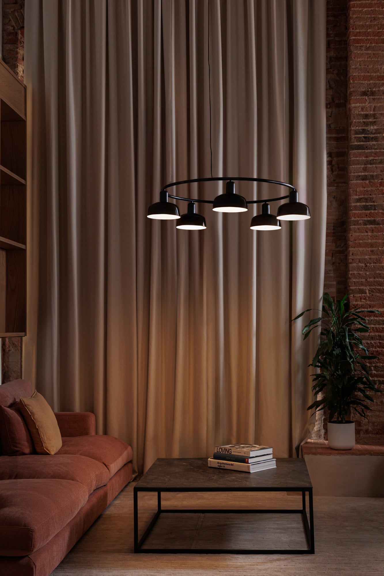 Faro Barcelona 5 Light Circular pendant in Black over a coffee table